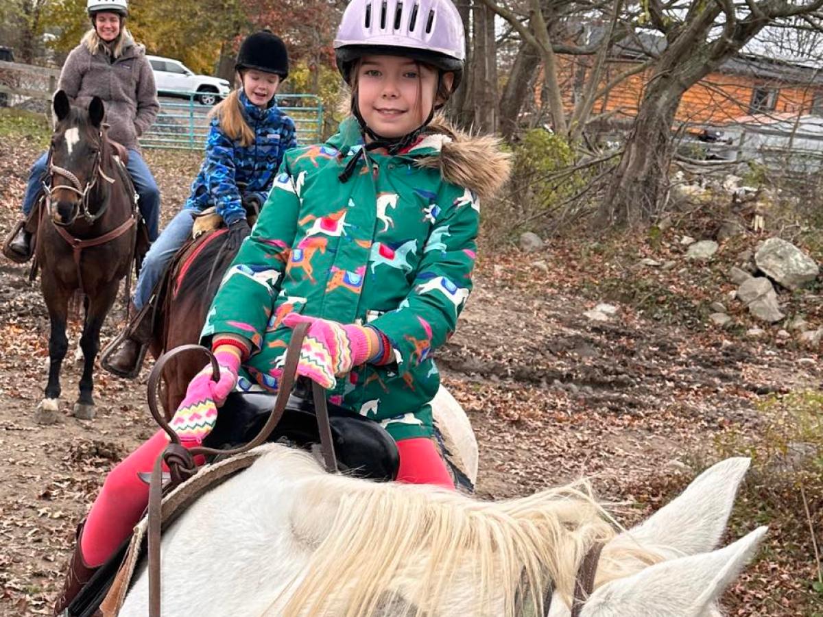 a group of people riding on the back of a horse