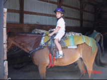 Young girl sitting on horse in a western saddle