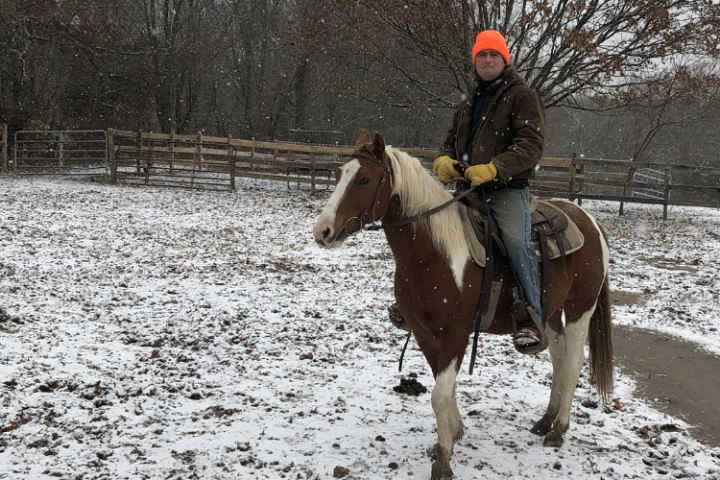 a person riding a horse in the snow