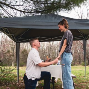 a man standing next to a tree
