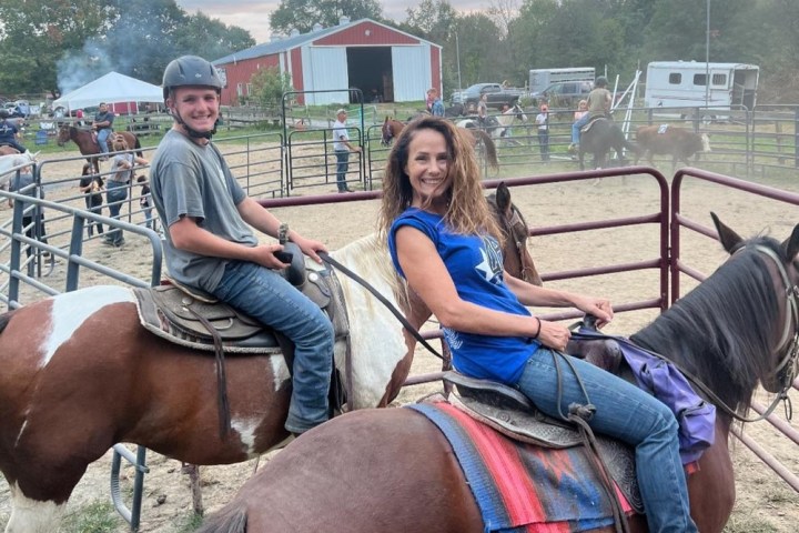 a group of people sitting on a horse