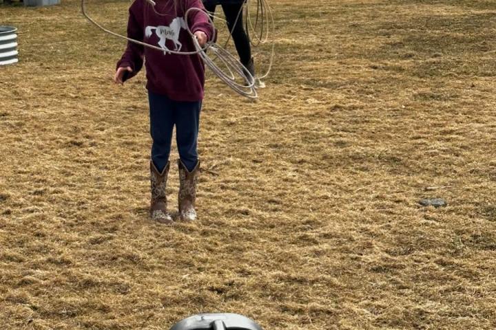 a young girl standing in a field
