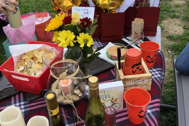 a person sitting at a table with food and drinks