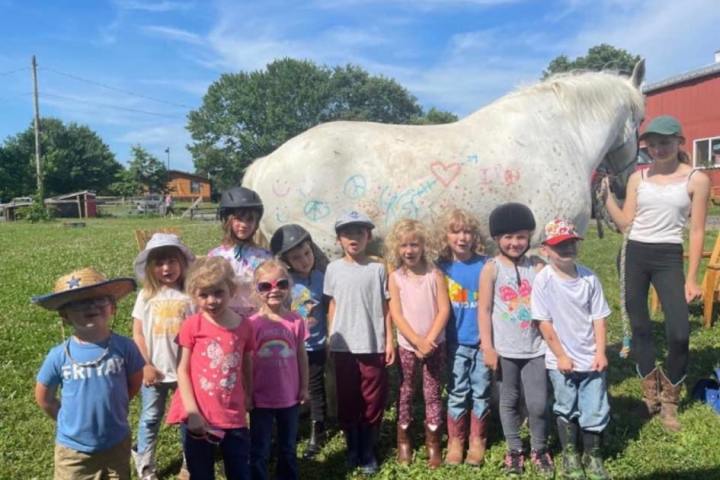 a group of people standing in the grass