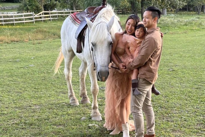 Liza Lapira riding a horse in a field