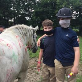 a person petting a horse