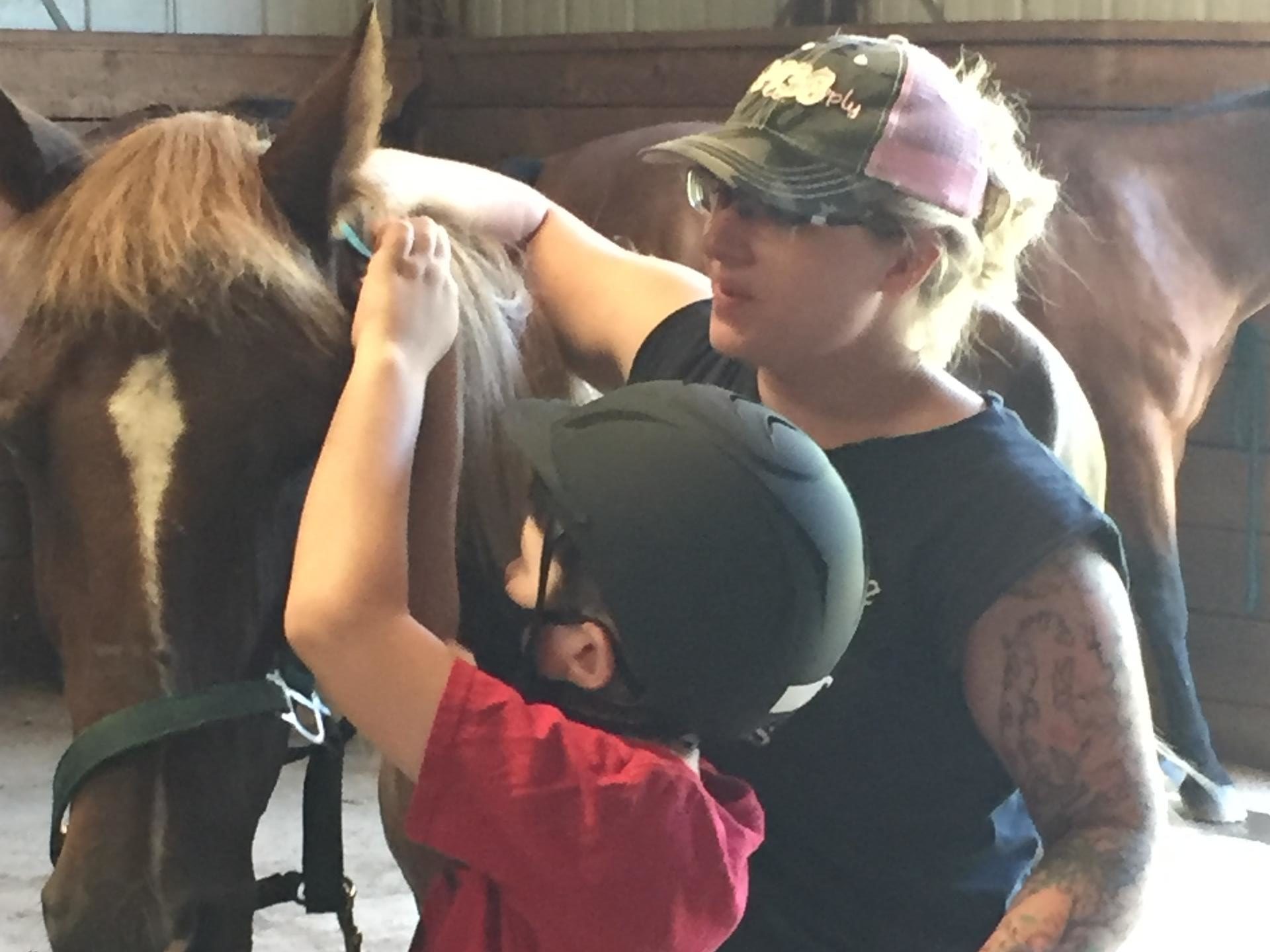 a person standing in front of a horse