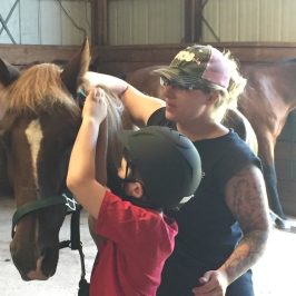a person standing in front of a horse