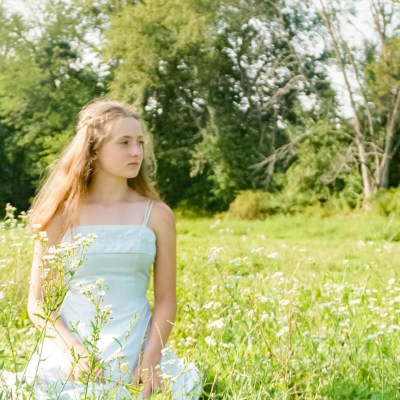 a woman that is standing in the grass