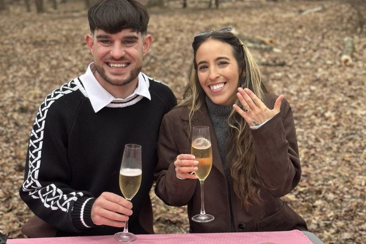 a person sitting at a table with a cake