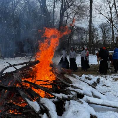 a group of people riding skis across snow covered ground