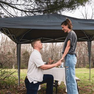 a man standing next to a tree