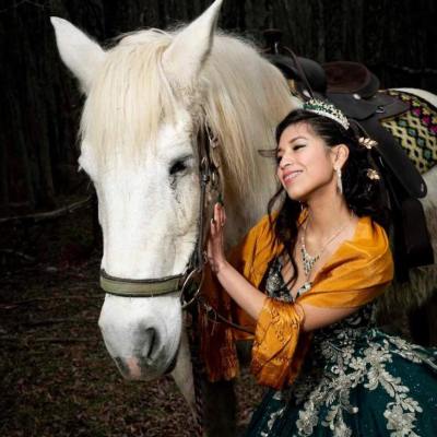 a woman standing next to a horse