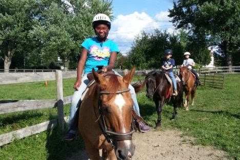 a man riding a horse on a dirt road