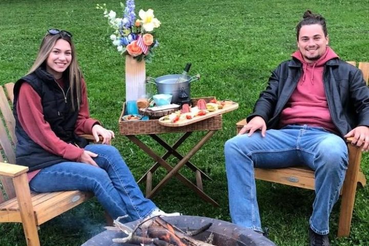 a group of people sitting on a bench in a park