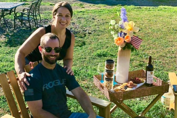 a person sitting on a bench with a dog