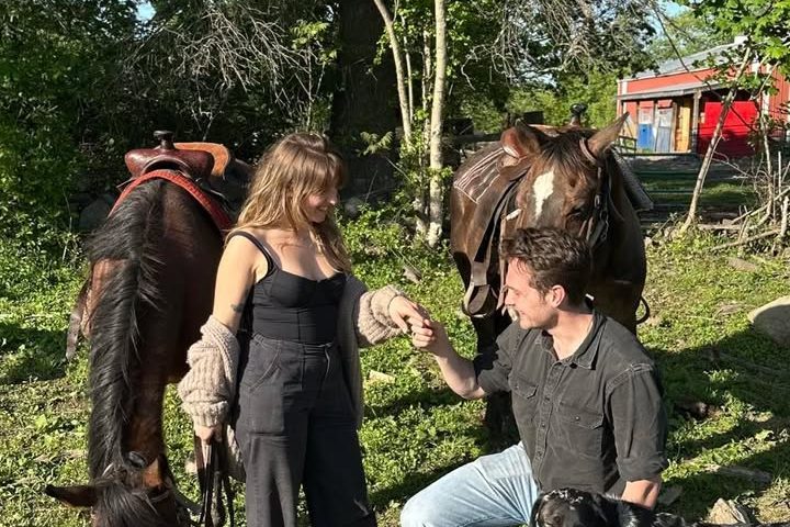 a couple of people that are standing in the grass
