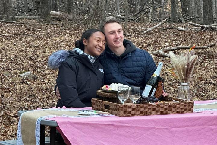 a person sitting at a picnic table