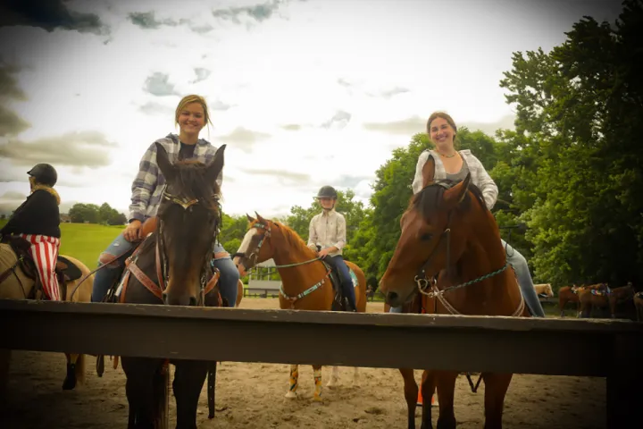 a group of people sitting on a horse