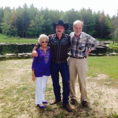 a man standing on top of a grass covered field