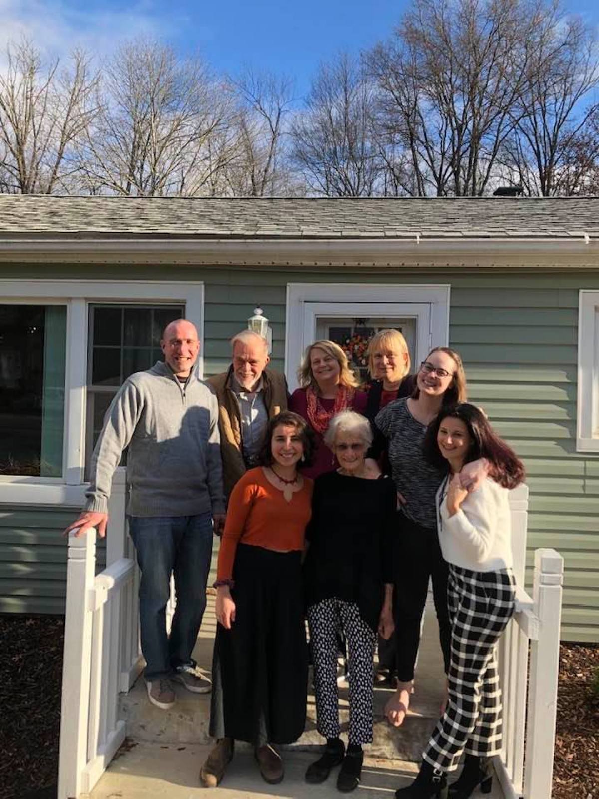 a group of people posing in front of a building