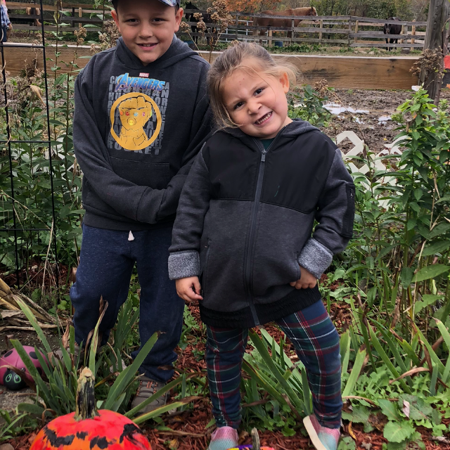 a little boy that is standing in the grass