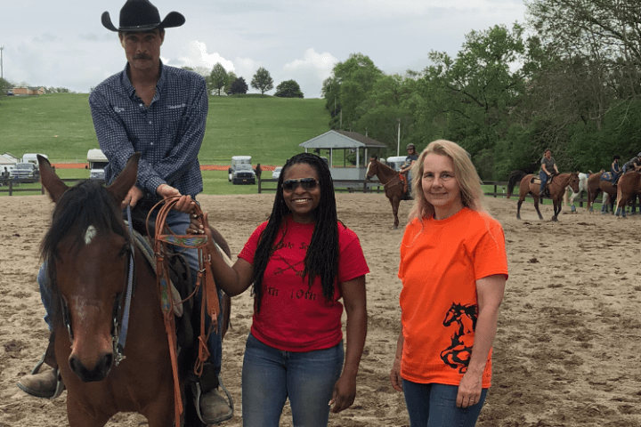 Marie et al. standing next to a horse