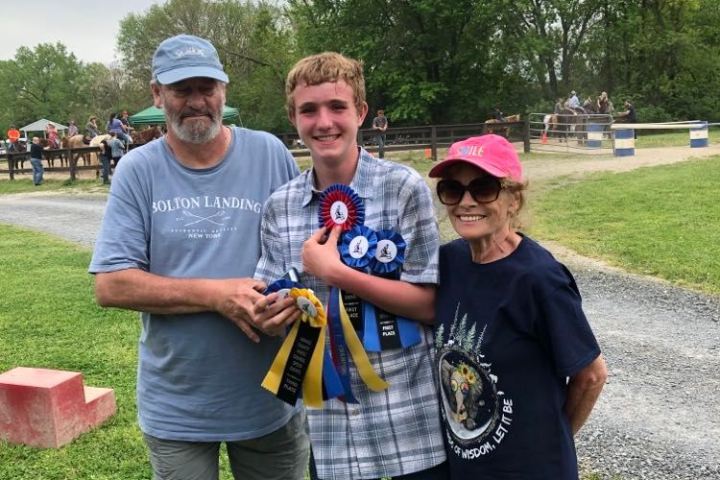 a group of people standing in the grass