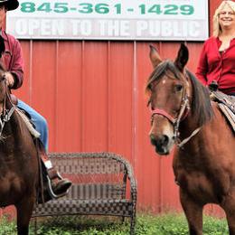 a couple of people that are standing in front of a horse