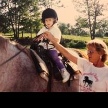 a young man riding a horse
