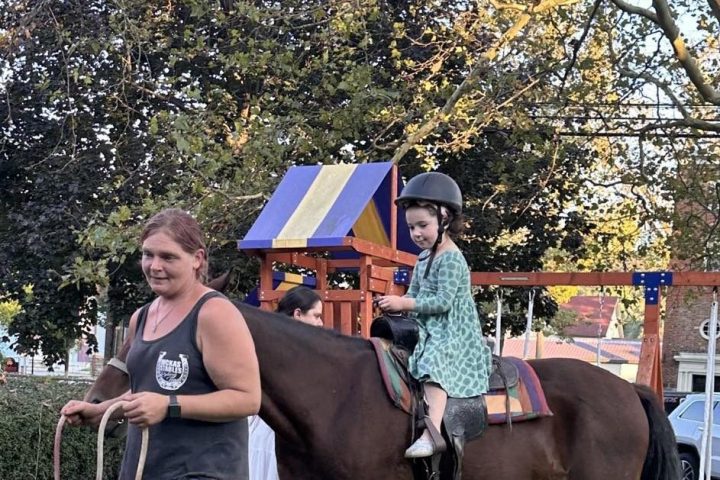 a group of people that are standing in the grass