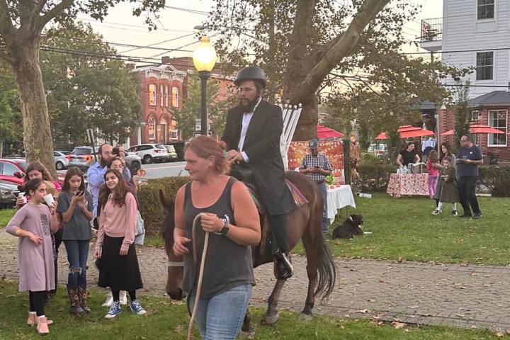 a group of people that are standing in the grass