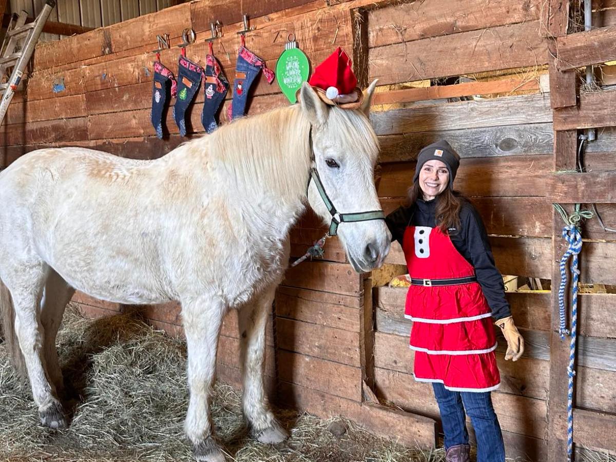 a group of people standing next to a horse