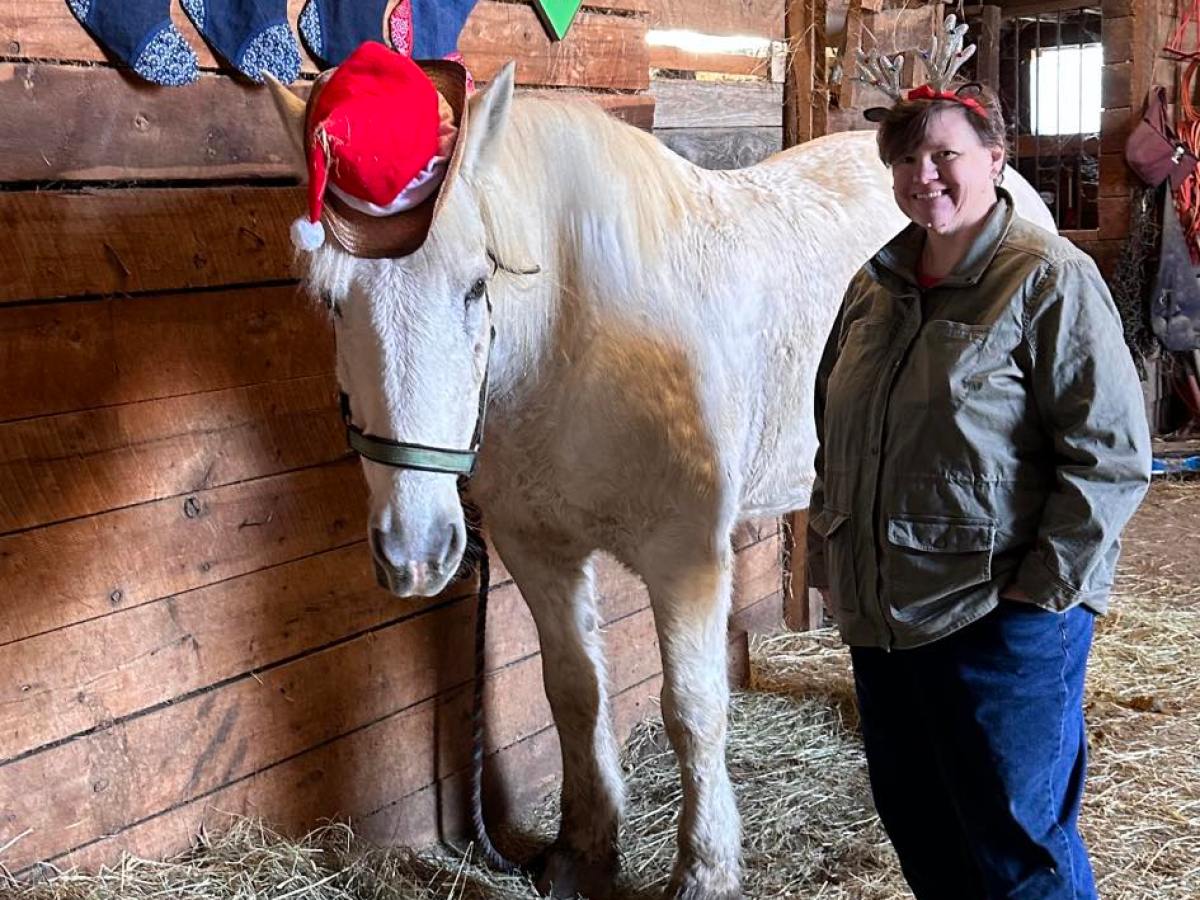 a man standing next to a horse